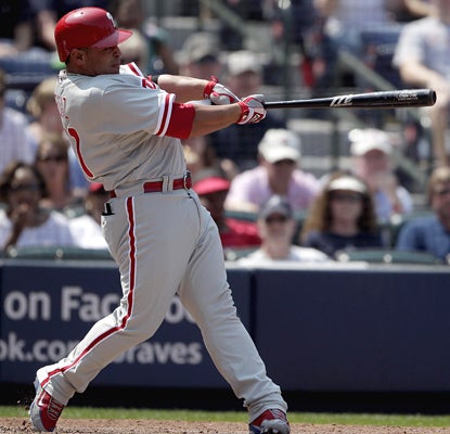 Carlos Ruiz connects on a pinch-hit grand slam in the seventh inning to help the Phillies bury the Braves. (AP)