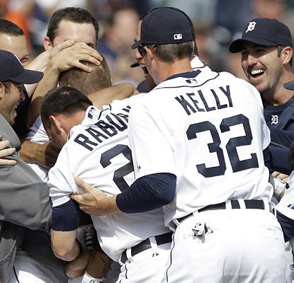 Brandon Inge, hidden in a swarm of teammates, is Detroit's latest ninth-inning hero after blasting a HR on the first pitch.  (AP)