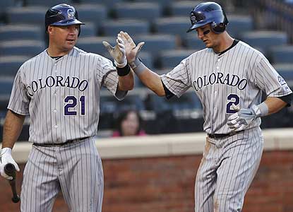 Troy Tulowitzki (right) hits HR No. 2 of the day to help the Rockies (10-2) take all four games of the series from the Mets. (AP)