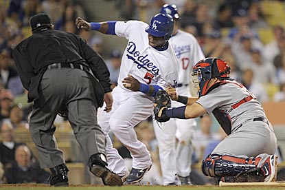 Yadier Molina tags out Juan Uribe, who tries to score on Jamie Hoffmann's grounder to shortstop in the third inning.  (AP)