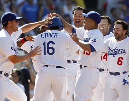 Los Angeles' Andre Ethier is mobbed at the plate after Matt Kemp's game-winning homer. (AP)