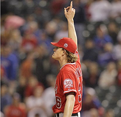 Angels starter Jered Weaver points skyward at a pop-up for the final out in the ninth to earn his fifth win of the season. (AP)