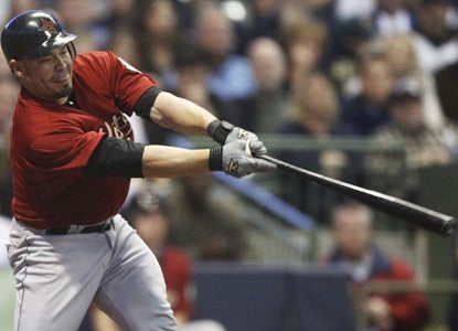 Humberto Quintero stretches for a double that scores two runs in the 10th inning as the Astros top the Brewers. (AP)