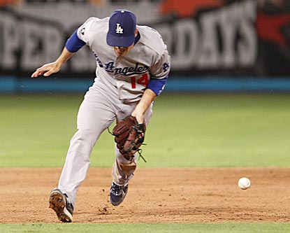 Jamey Carroll misplays Scott Cousins' potential game-ending grounder moments before Jerry Sands misjudges Omar Infante's liner. (AP)