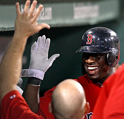 Mike Cameron is greeted with high-fives from teammates after belting his second solo HR in a home loss for the Red Sox. (AP)