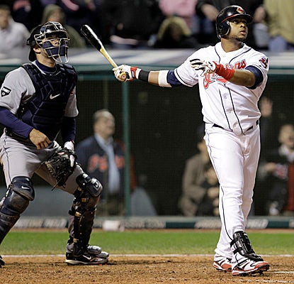 Carlos Santana watches the flight of his walk-off grand slam as the Indians best Detroit. (AP)