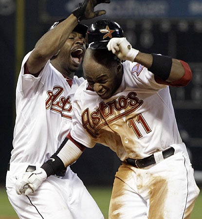 Michael Bourn (left) congratulates Jason Bourgeois on his game-winning single in the ninth inning. (AP)