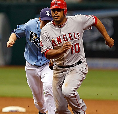 Vernon Wells gets caught in a run-down in the eighth inning as the Angels rally for the win. (AP)