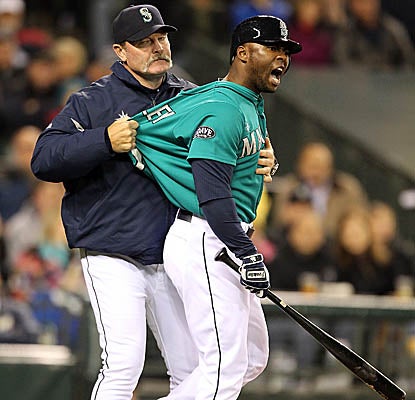 Milton Bradley is restrained by Mariners manager Eric Wedge after getting tossed vs. the White Sox. (Getty Images)