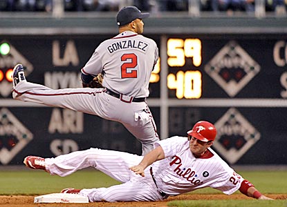 Braves shortstop Alex Gonzalez avoids the slide of the Phillies' Brian Schneider during the second inning. (US Presswire)