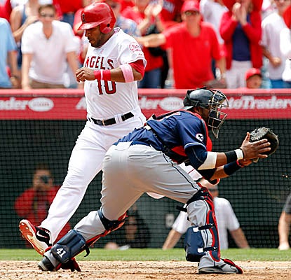 Vernon Wells crosses the plate on a double by Alberto Callaspo as the Angels edge the Indians. (AP)