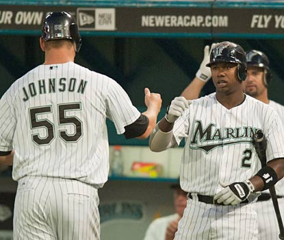 Josh Johnson is greeted by Hanley Ramirez after scoring the first of Florida's two runs -- all it needs vs. Roy Halladay.  (US Presswire)