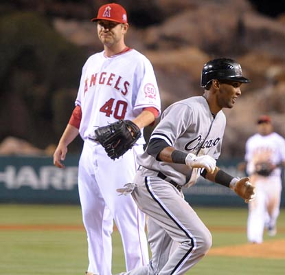 Alexei Ramirez pops up from scoring the eventual winning run as Kevin Jepsen looks on in dismay.  (US Presswire)