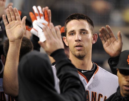 San Francisco's Madison Bumgarner is congratulated by teammates after scoring on a sacrifice fly. (AP)