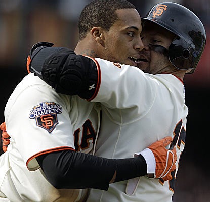 Speedy Darren Ford (left) scores the winning run in the bottom of the 11th for the red-hot Giants.  (AP)