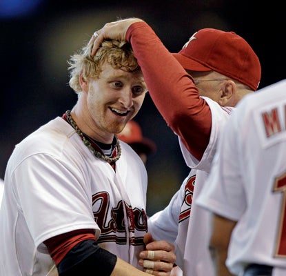 Astros manager Brad Mills congratulates J.R. Towles after Towles' game-winning hit in the 9th inning vs. Los Angeles. (AP)