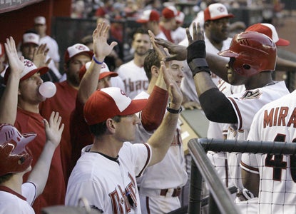 Justin Upton (right) ties a career best at the plate by going 5-for-5 to help the D-Backs rout the Marlins in epic fashion. (AP)