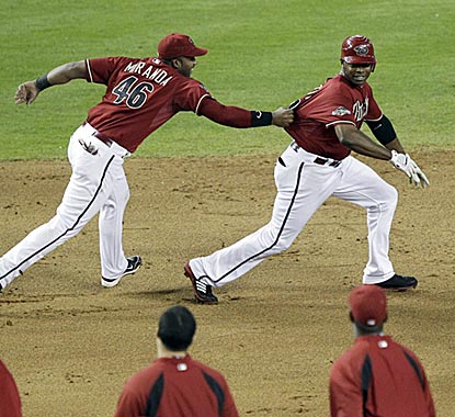 The walk-off chase is on in Phoenix, and first baseman Juan Miranda is the first to get to Diamondbacks hero Justin Upton.  (AP)