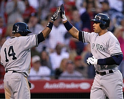 Alex Rodriguez (right) high-fives Curtis Granderson after hitting a two-run homer in the sixth inning. (Getty Images)