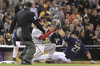 Anthony Rizzo slides in with a triple in his second at-bat as a major-leaguer. He scores a few batters later.  (AP)