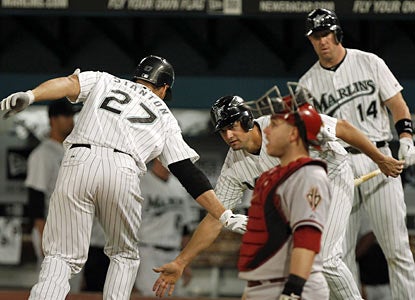 Gaby Sanchez congratulates Mike Stanton after Stanton reaches home plate following his two-run homer in the sixth. (AP)