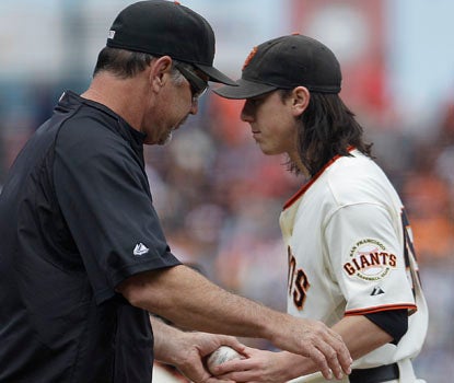Giants manager Bruce Bochy makes a pitching change as Tim Lincecum fails to get out of the fifth inning vs. the Reds. (AP)