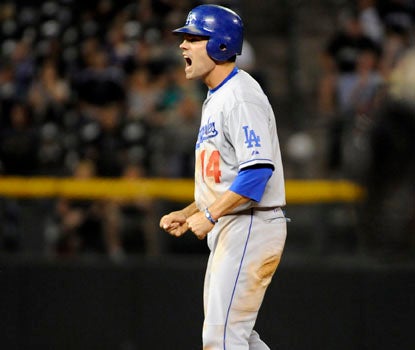 The Dodgers' Jamey Carroll collects four hits, and celebrates a ninth-inning double vs. Colorado. (AP)