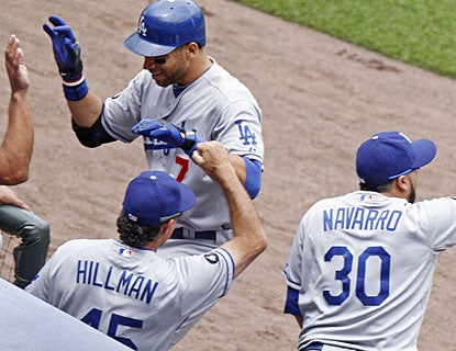 James Loney gets cheers from the bench after smacking a grand slam, the second of his career. (AP)