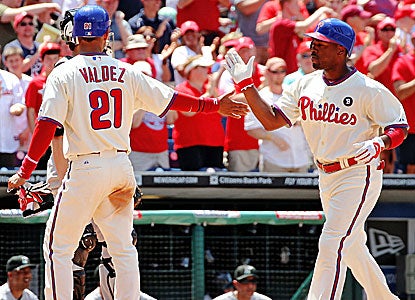 Wilson Valdez and Jimmy Rollins score in a six-run third inning against Elih Villanueva in his big-league debut.  (Getty Images)
