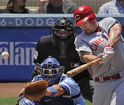 Scott Rolen pounds one of his three hits on the afternoon on the way to racking up three RBI for Cincinnati.  (AP)