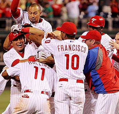 The Phillies mob Carlos Ruiz following his  two-out, game-winning hit in the 10th inning.  (Getty Images)