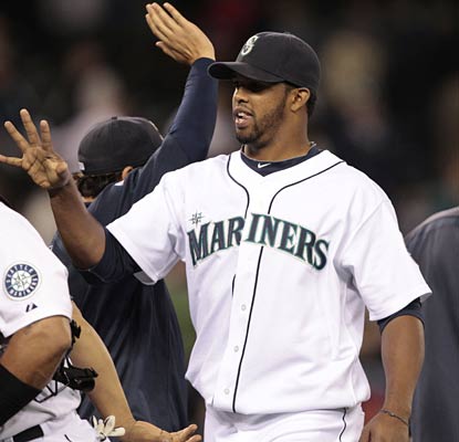 Carlos Peguero goes through the celebration line after his two-RBI single bounces off second base in the seventh.  (AP)