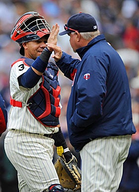 Manager Ron Gardenhire, high-fiving Rene Rivera, says the Twins 'haven't been able to put our team on the field since day one.' (Getty Images)