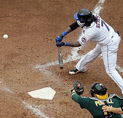 Mets shortstop Jose Reyes connects for one of his two RBI singles as the Mets top the A's. (Getty Images)