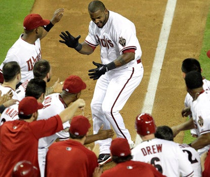 Wily Mo Pena joins the celebration at home plate, after his walk-off homer beats the Indians. (AP)