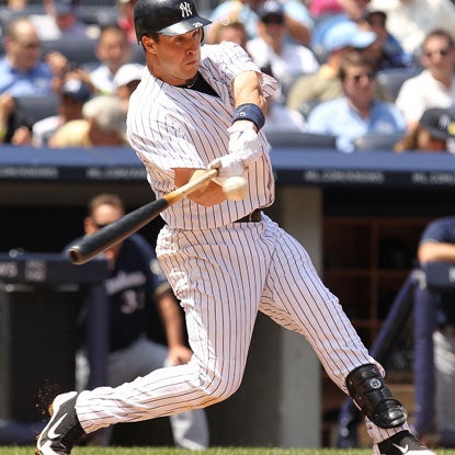 Mark Teixeira drives it out of the park for the 25th time this season to reach the 300-homer plateau for his career. (Getty Images)
