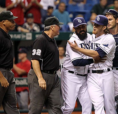 Rays reliever J.P. Howell spikes his glove and baseball on the ground after giving up a home run, earning him an ejection.  (US Presswire)