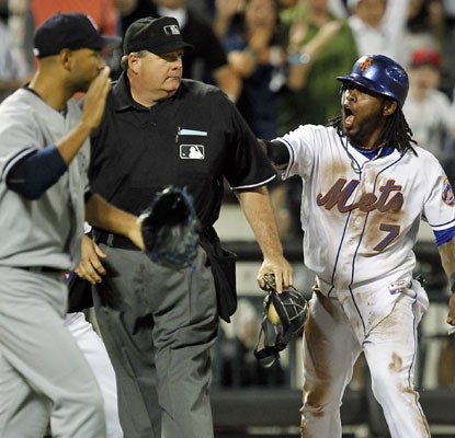 Jose Reyes does not agree with the umpire after he is called out on a controversial play at third base.  (US Presswire)