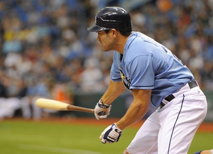 Johnny Damon awkwardly swings through a bases-loaded triple before finishing the game with four RBI. (Getty Images)