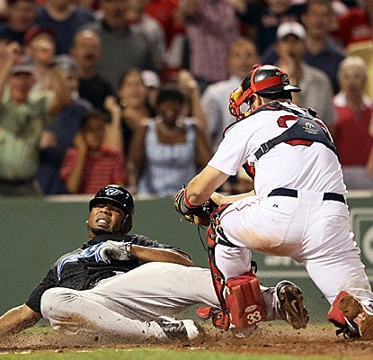 Edwin Encarnacion is called out at home plate for the final out of the game, preserving a Boston victory. (Getty Images)