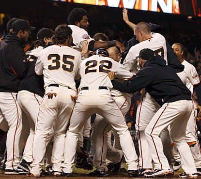 Giants players jump for joy around Nate Schierholtz, whose second home run of the game is the winner. (US Presswire)