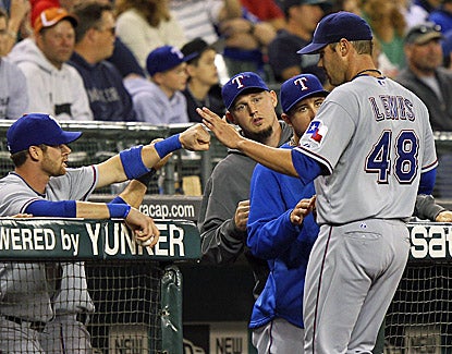 Colby Lewis is congratulated after shutting down the M's, throwing 8 2/3 innings and falling one out shy of a complete game. (Getty Images)