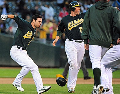 Scott Sizemore (left) celebrates after getting the game-winning hit during the 10th inning against the Angels. (US Presswire)