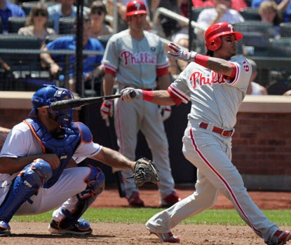Michael Martinez watches his first major-league homer leave the ballpark. The three-run shot helps Philly beat New York. (AP)