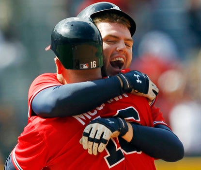Freddie Freeman celebrates his game-winning hit with Brian McCann, as Atlanta pulls out a dramatic comeback. (AP)
