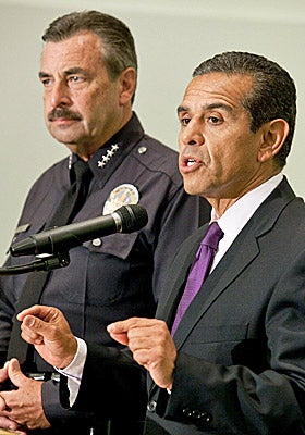 Charlie Beck (left) and Mayor Antonio Villaraigosa announce the arrest of two new suspects in the beating of a Giants fan. (AP)