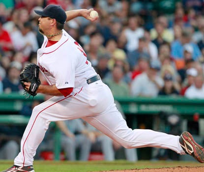 Josh Beckett wins his ninth game of the season, striking out seven Mariners in seven innings of work. (AP)