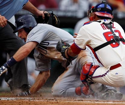 Chris Denorfia slides home safely past the tag of Carlos Ruiz, giving San Diego a 3-1 second-inning lead. (AP)