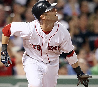 Dustin Pedroia continues to swing away, connecting four times to reach 23 consecutive games with at least one hit. (Getty Images)