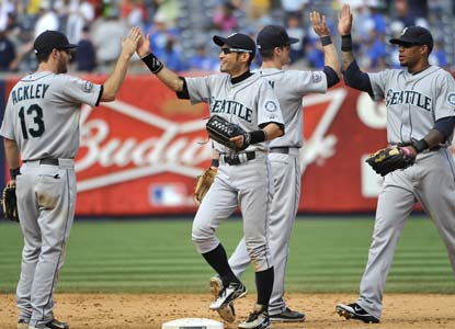 The M's celebrate after taking out 21 days of frustration on New York to end the majors' longest skid since 2005 (K.C.). (AP)